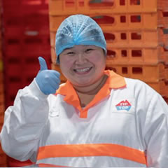 Woman in hair net smiling with thumbs up
